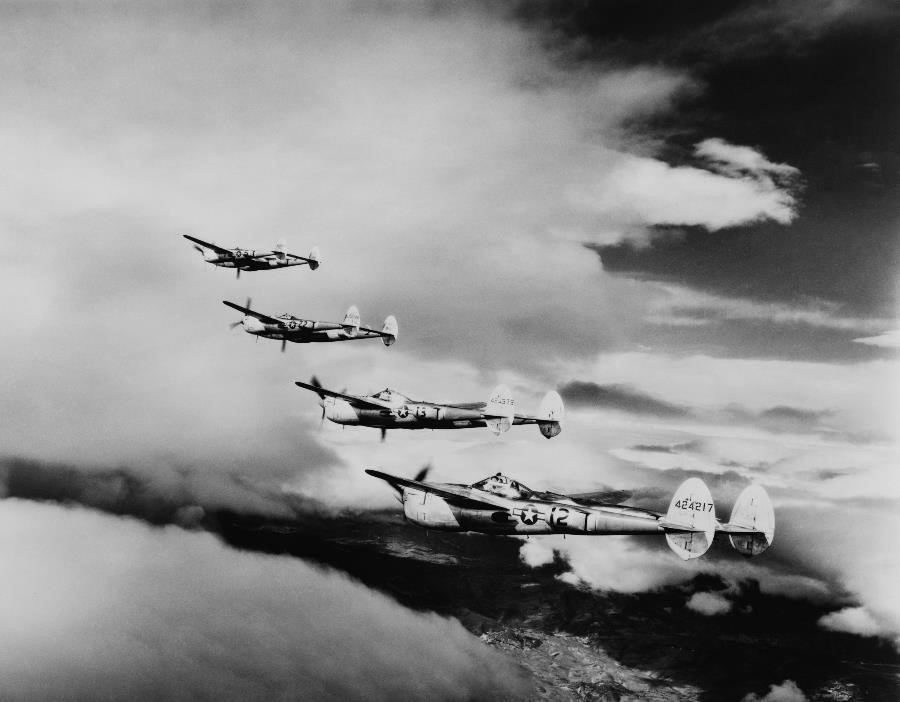 An archival photo shows U.S. Air Force bombers flying in formation during World War II.