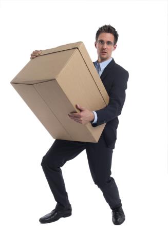 man in a business suit holding a large cardboard box