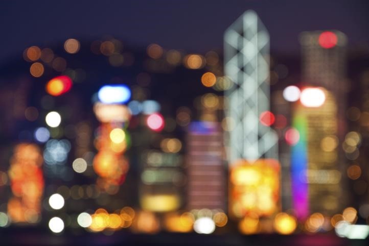 An out of focus, blurred shot of a city skyline at night.