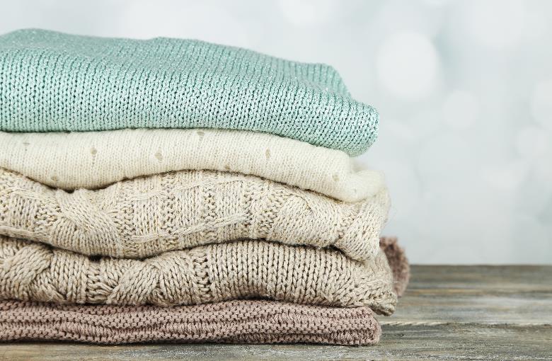 A stack of folded winter sweaters.