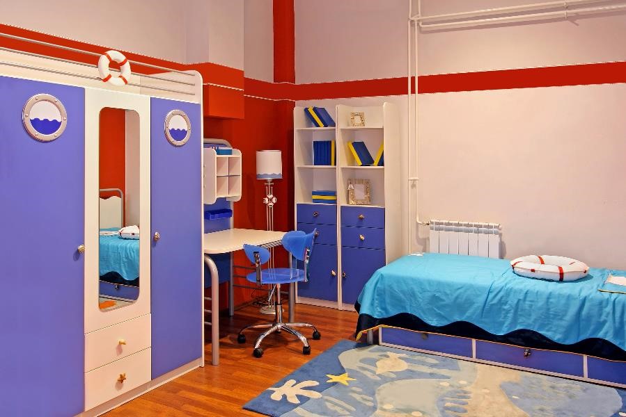A nautical themed children's room, with porthole decorations, life preservers, etc.