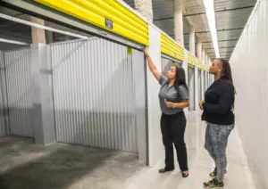 A Safeguard storage facility employee shows a renter an empty storage unit.