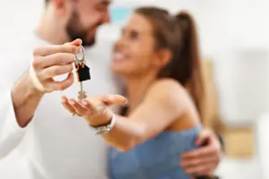 A man and woman holding keys
